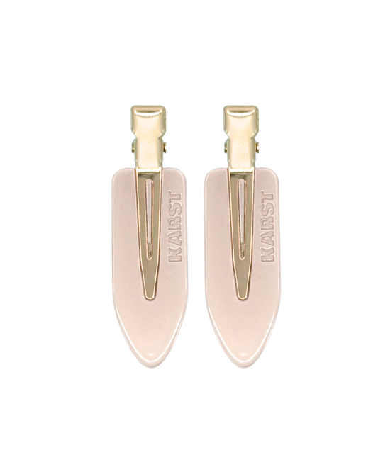 Pair of beige shoe trees with gold clips on a white background
