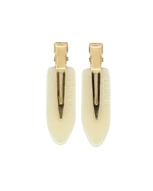 Gold barrettes on a white background
