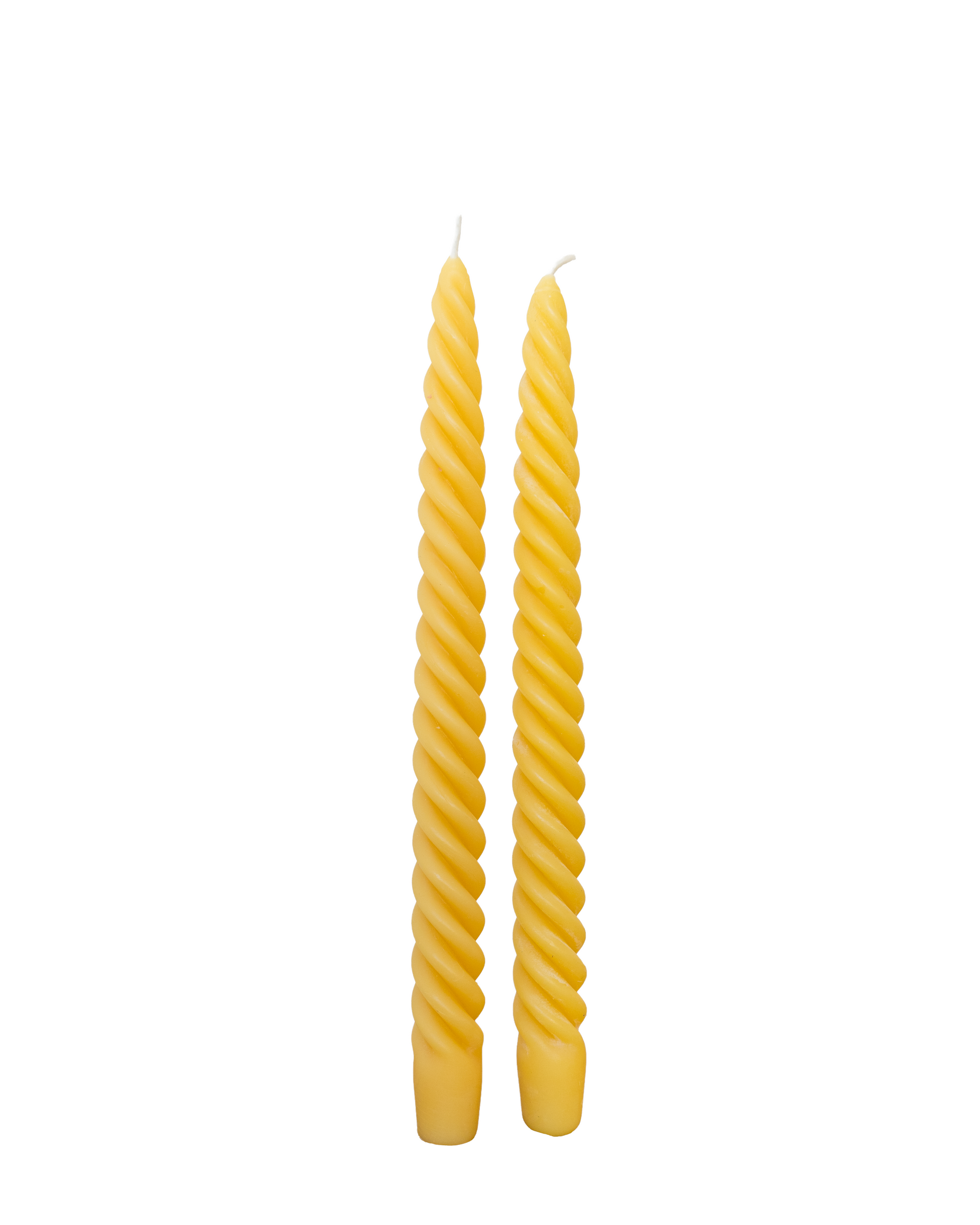Two twisted yellow candles on a white background