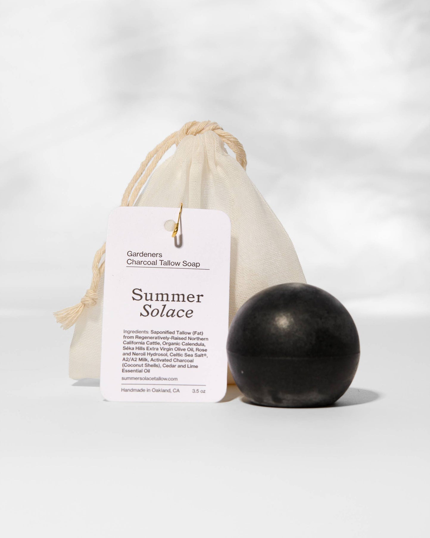 Black soap bar with a 'Summer Solace' label on a white background