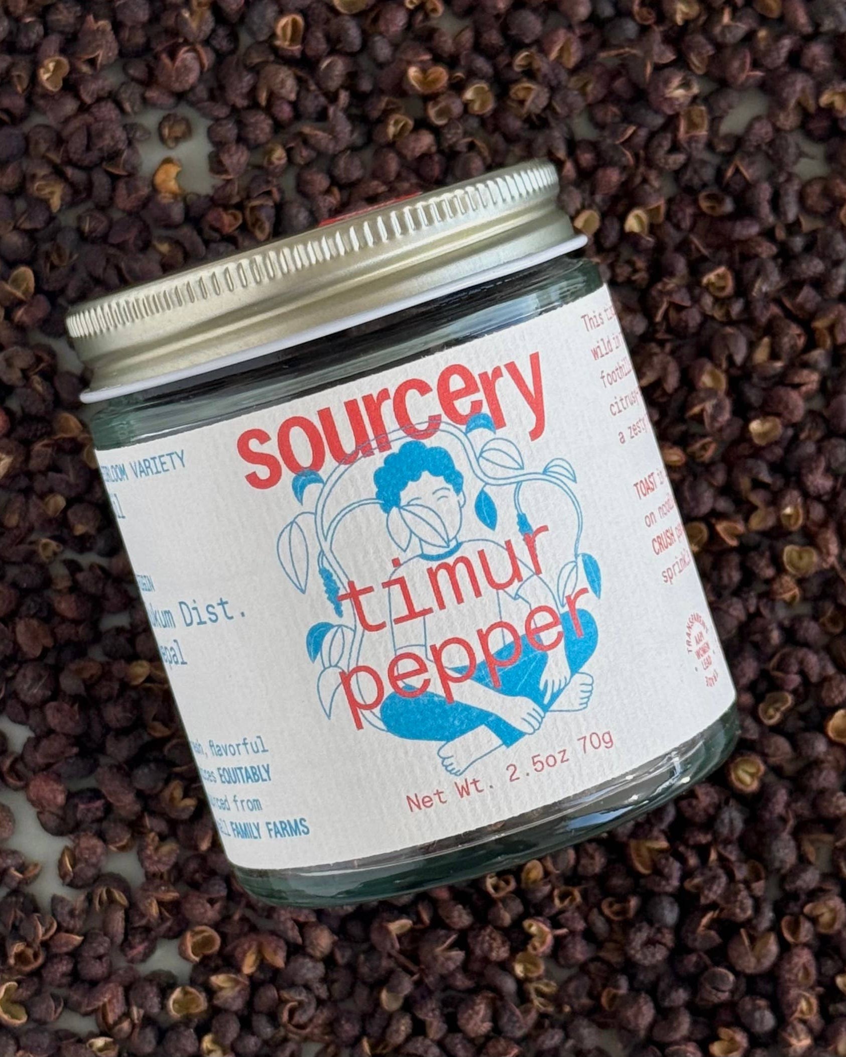 Jar of 'sourcery' timur pepper on a bed of peppercorns