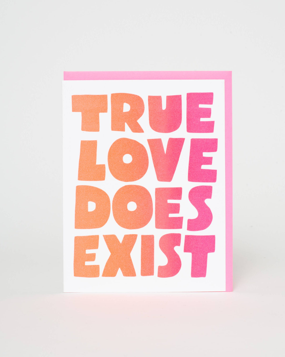 Card with 'True Love Does Exist' text in pink and orange on a white background