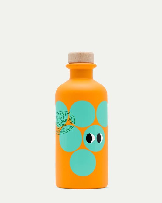 Orange bottle with green polka dot design on a white background