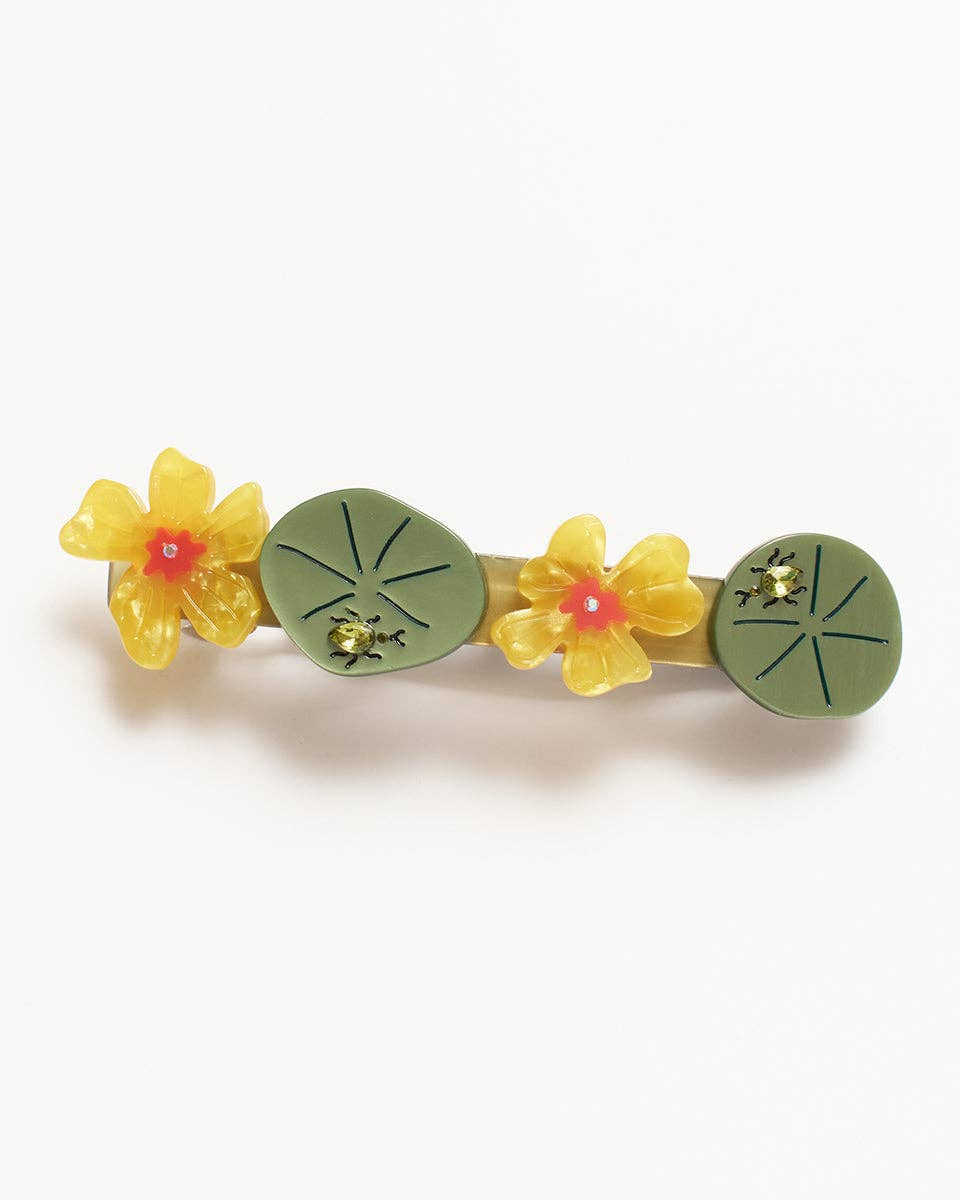 Decorative hair clip with flowers and leaves on a white background