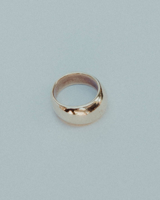 Gold ring on a light gray background