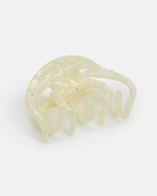 Clear plastic hair clip on a gradient background