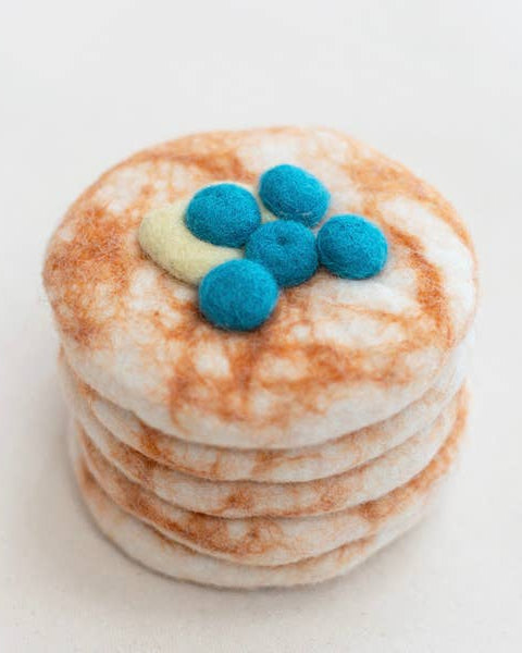 Stack of pancakes with blueberries on a white background