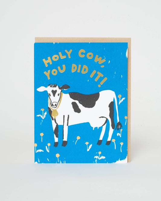 Greeting card with a cow illustration and text on a blue background