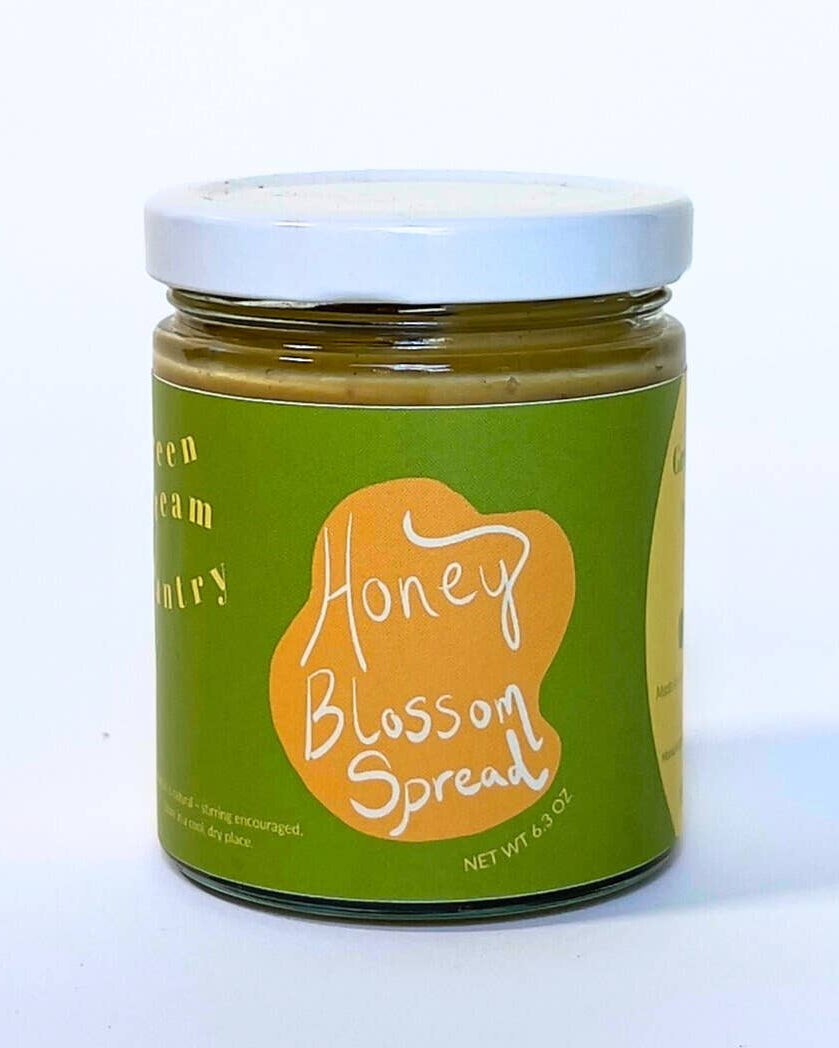 Jar of Honey Blossom Spread with a green label on a white background