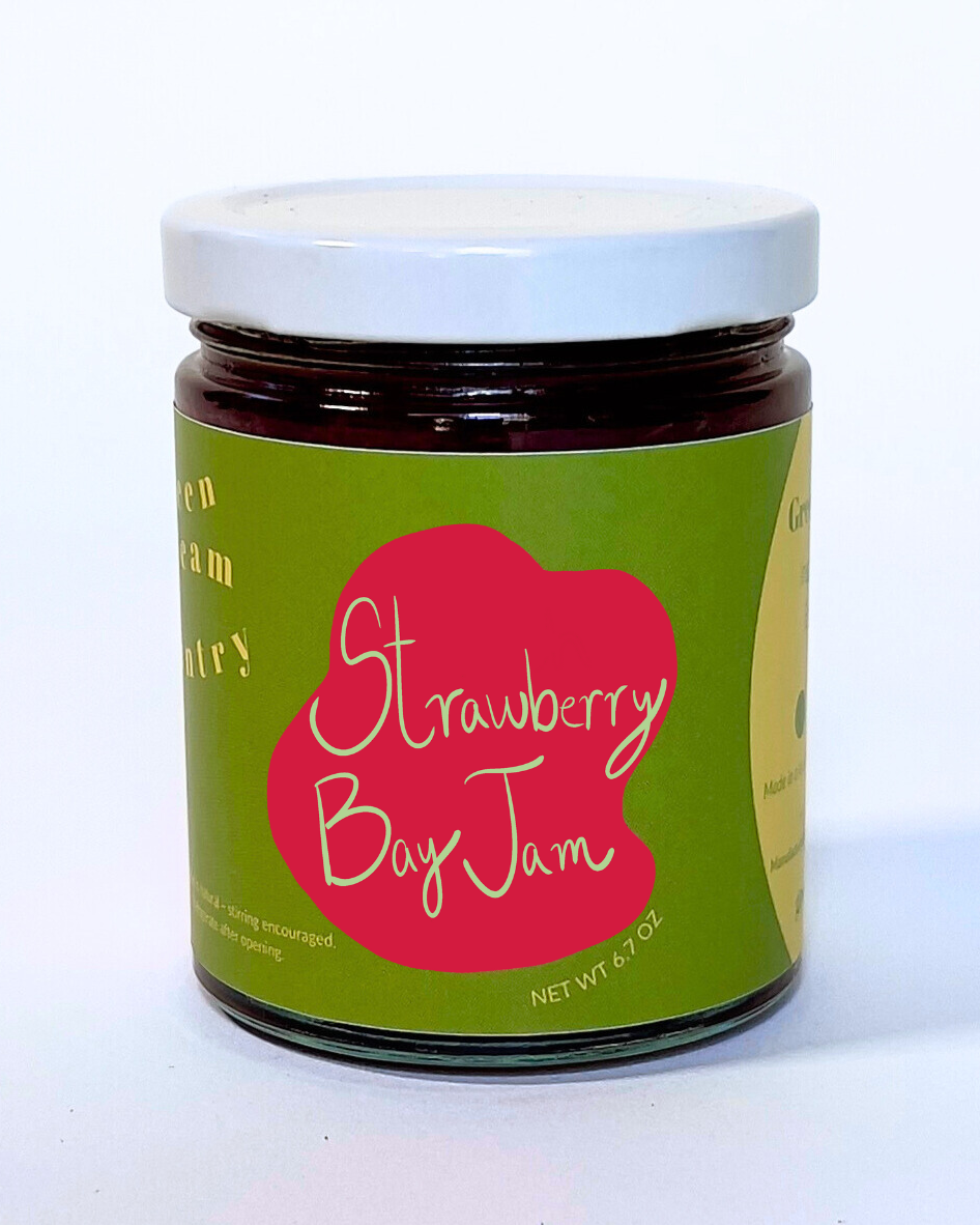 Jar of Strawberry Bay Jam with a green label on a white background