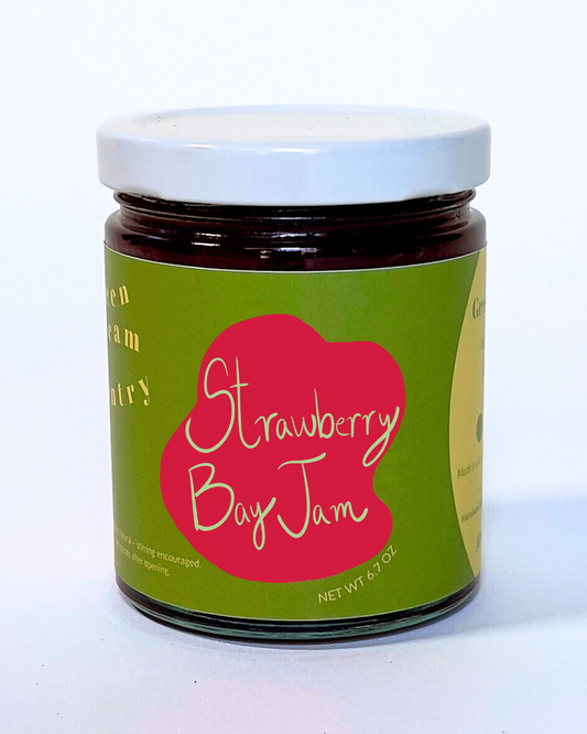 Jar of Strawberry Bay Jam with a green label on a white background