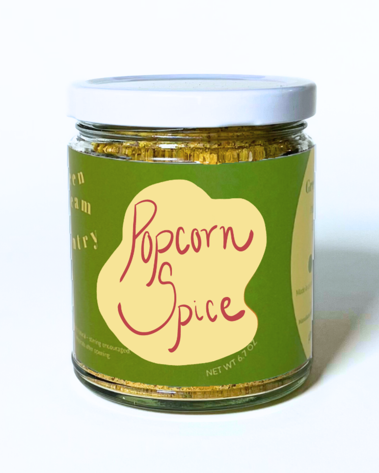 Jar of popcorn spice with a green label on a white background