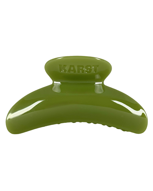 Green hair clip with 'KARST' branding on a white background