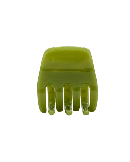Green hair clip on a white background