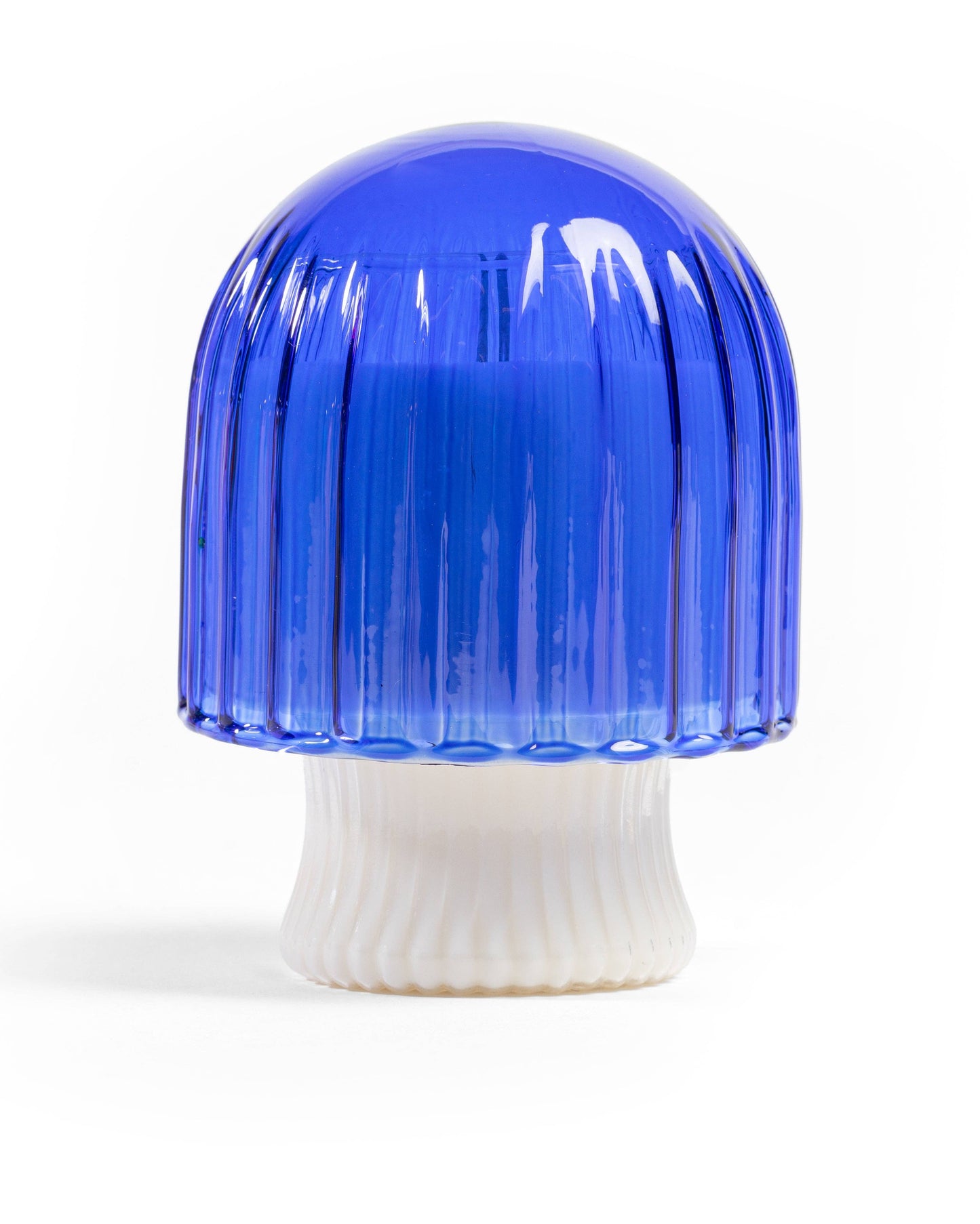 Blue and white ribbed glass vase on a white background
