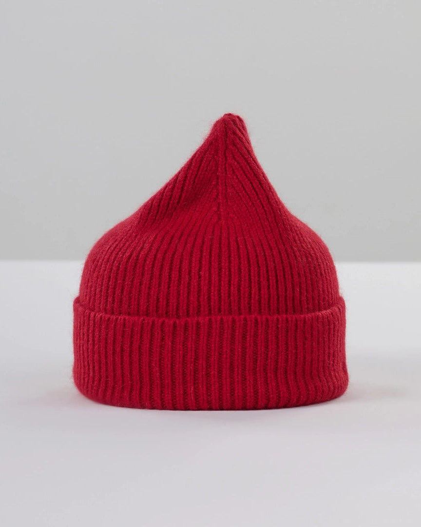 Red knitted beanie on a light gray background