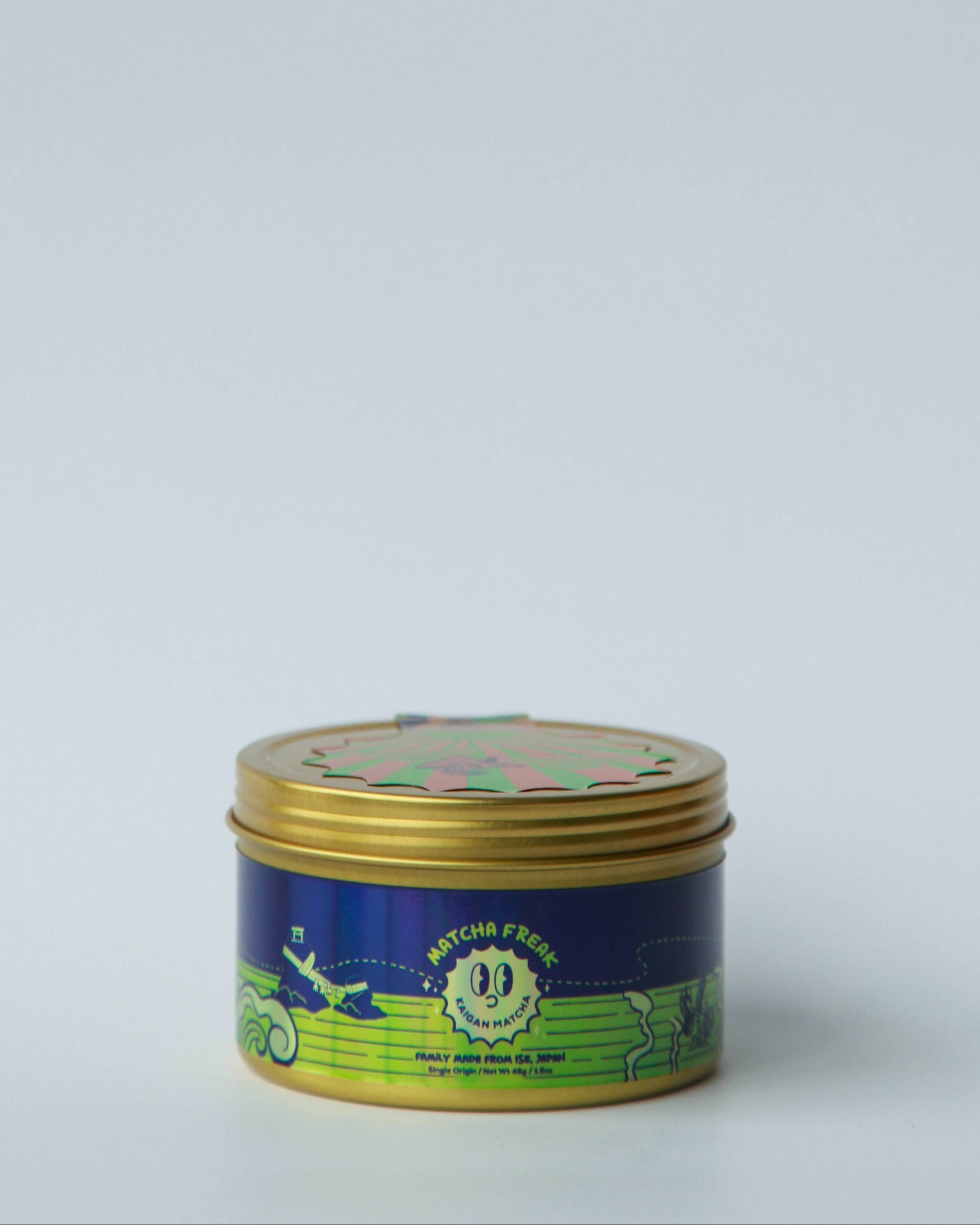 Metallic tin with green and gold design on a white background