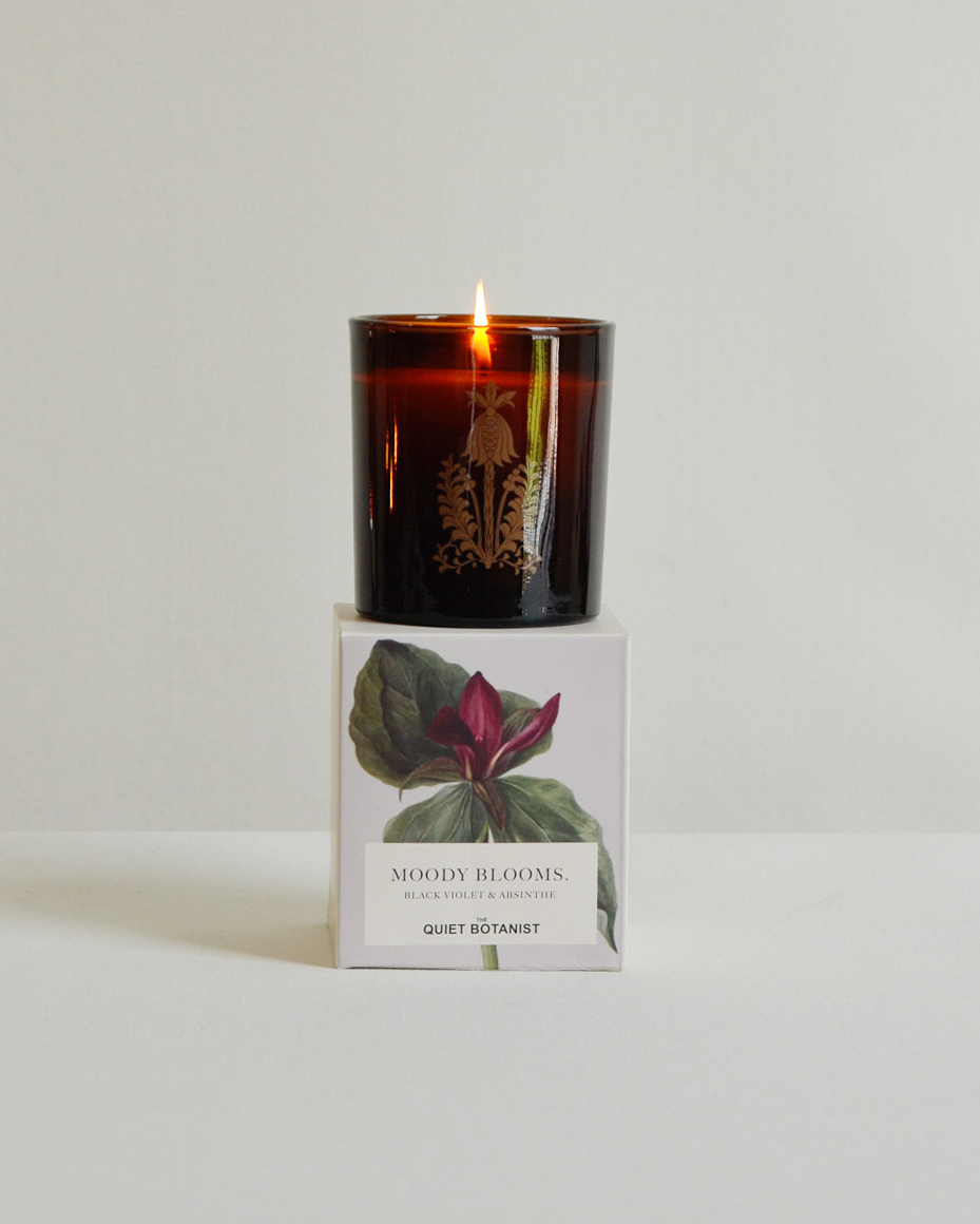 Candle with a decorative box on a white background