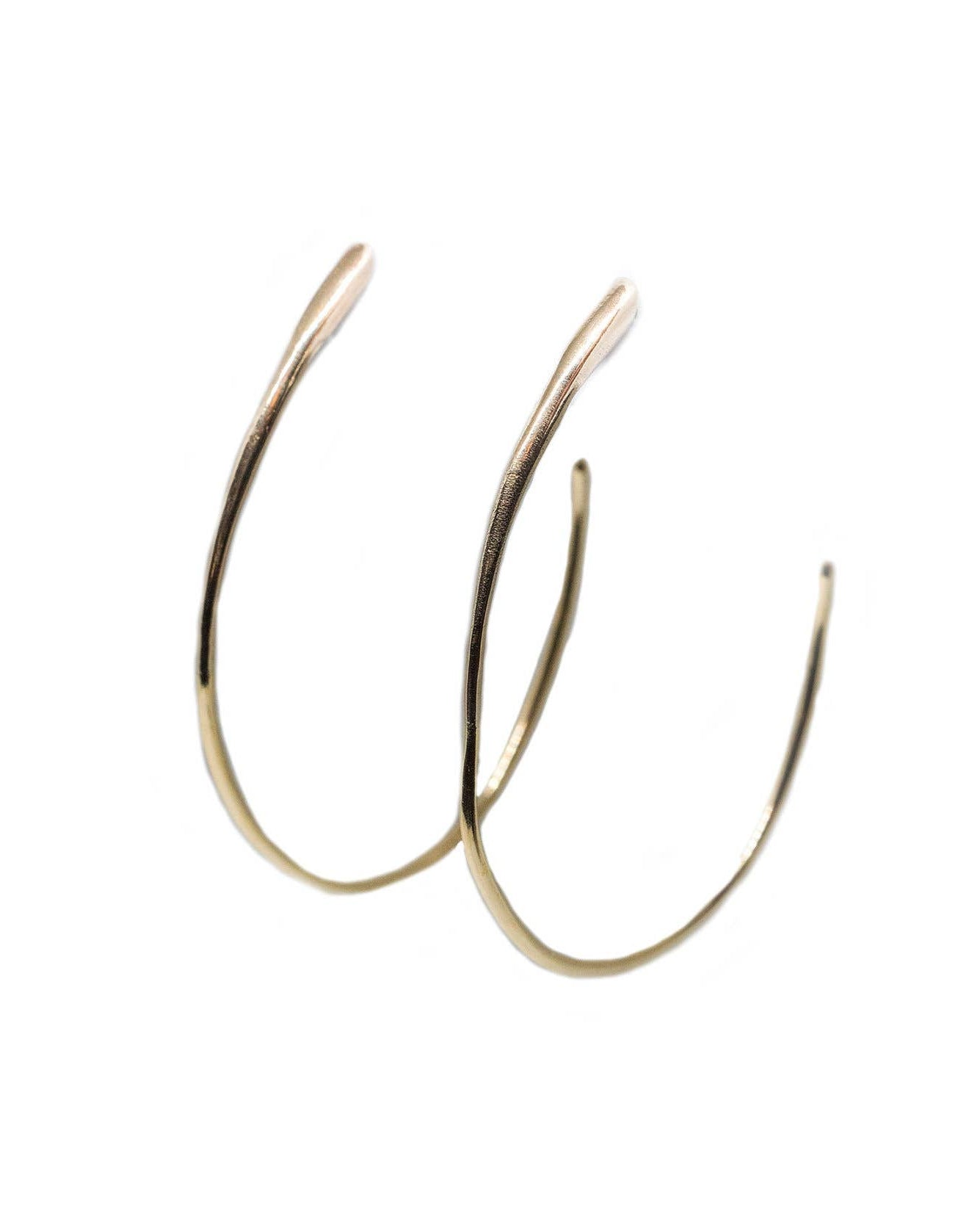 Gold hoop earrings on a white background