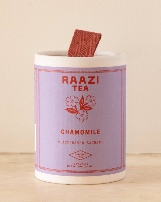 Raazi Tea chamomile tea packaging with a wooden spoon on a beige background