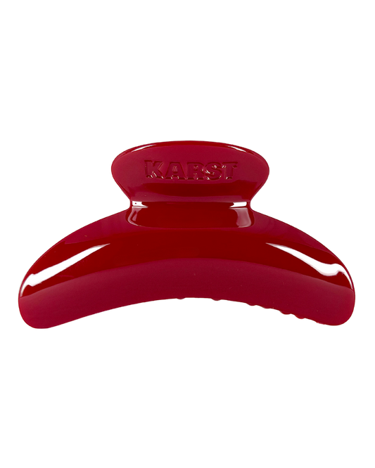 Red hair clip on a white background