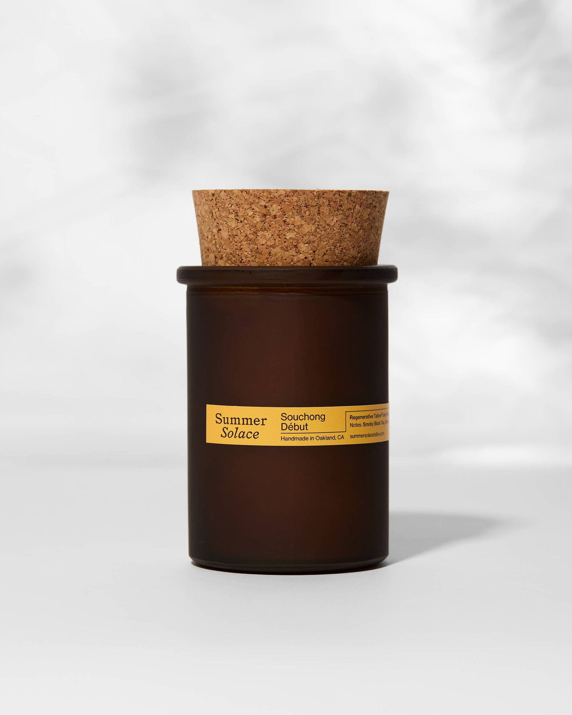 Candle with cork lid on a white background