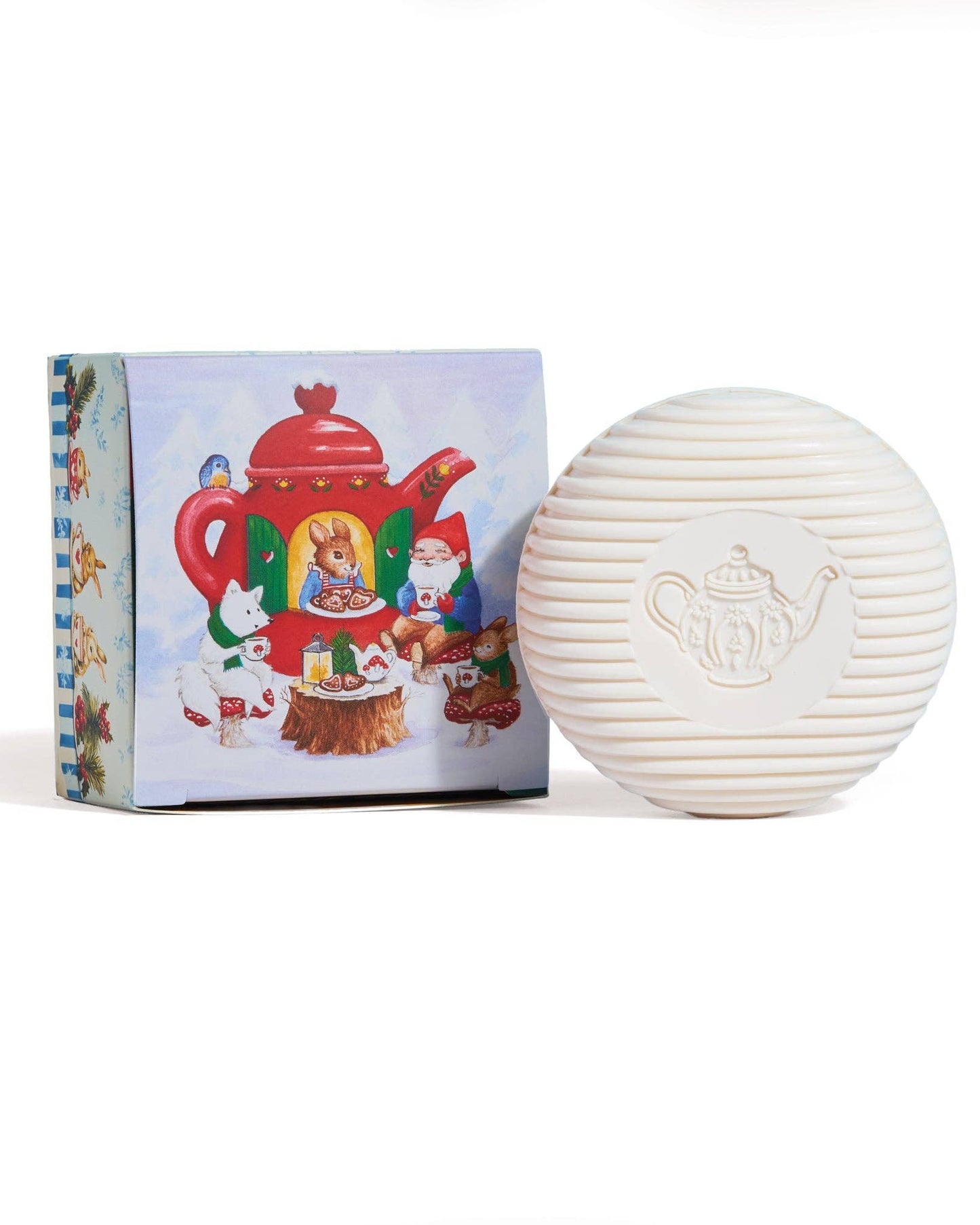 White spherical soap with teapot design next to a colorful box on a white background