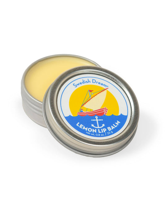 Lemon lip balm in a tin with a colorful label on a white background